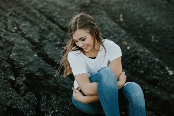 woman sitting on black soil during daytime