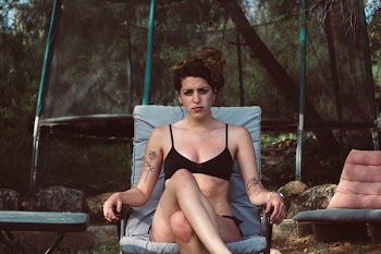 Woman Sitting on Black Steel Armchair