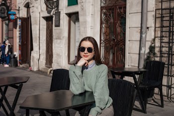 Woman Sitting on Black Wooden Chair