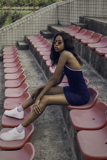 Woman Sitting on Bleachers