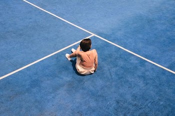 woman sitting on blue floor