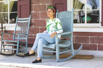 Woman Sitting on Blue Wooden Rocking Chair