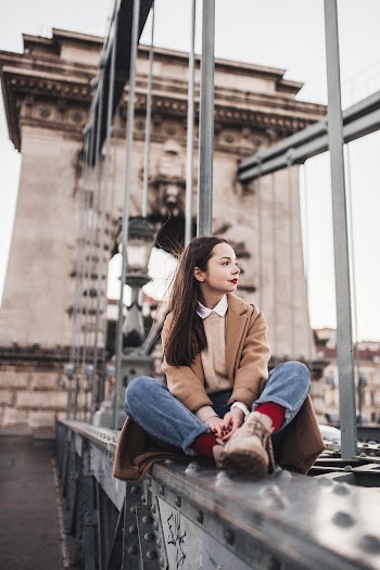 Woman Sitting on Bridge