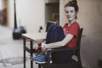 Woman Sitting on Brown Armchair Outside
