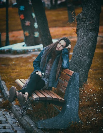 Woman Sitting On Brown Bench