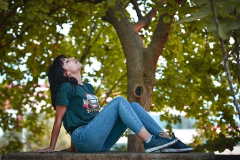 Woman Sitting on Brown Bench