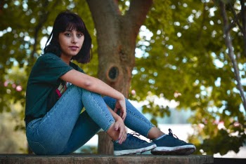 Woman Sitting on Brown Bench