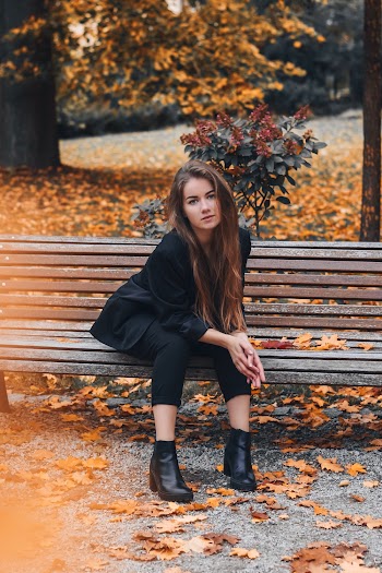 Woman Sitting on Brown Bench