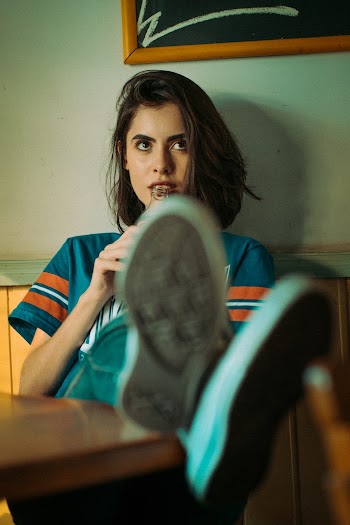 Woman Sitting on Brown Chair