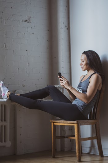 Woman Sitting on Brown Chair