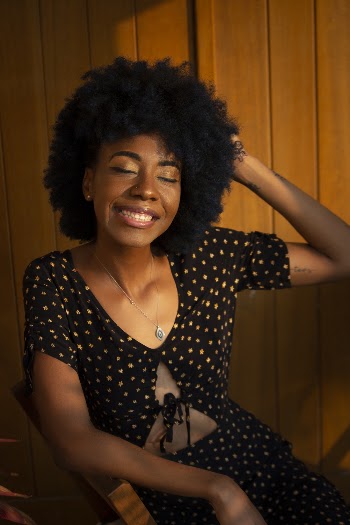Woman Sitting on Brown Chair