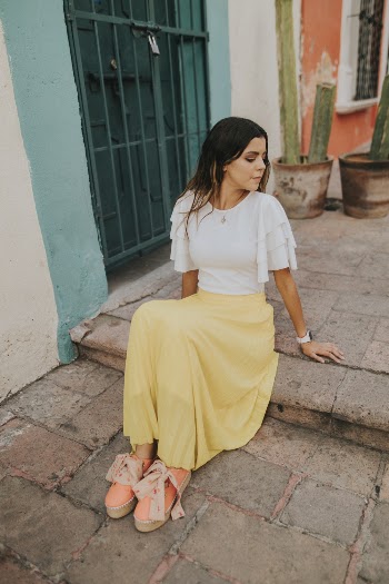 Woman Sitting on Brown Concrete Pavement