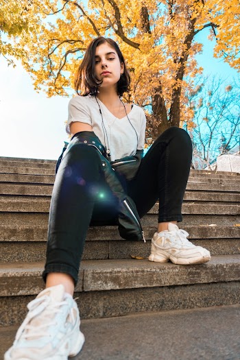 Woman Sitting on Brown Concrete Steps