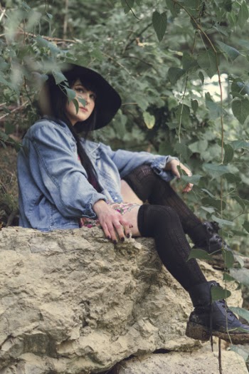 Woman Sitting on Brown Rock