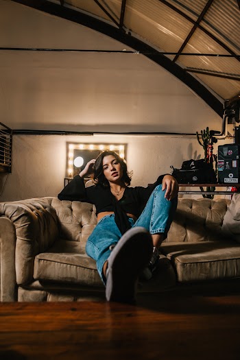 Woman Sitting on Brown Sofa