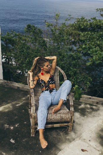 Woman Sitting On Brown Wicker Armchair 