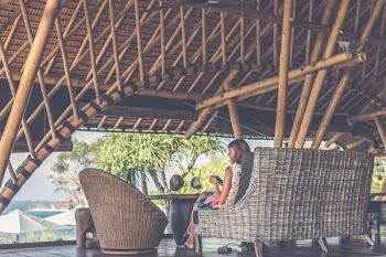 Woman Sitting On Brown Wicker Chair
