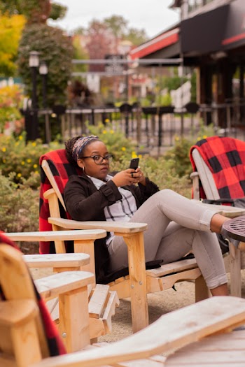 Woman Sitting On Brown Wooden Armchair
