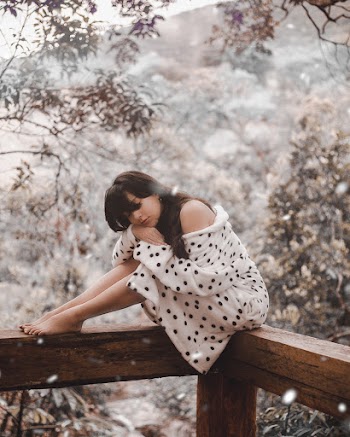 Woman Sitting On Brown Wooden Beam