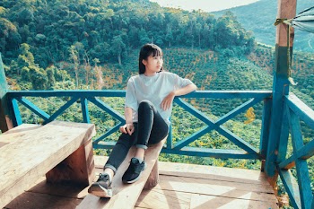 Woman Sitting on Brown Wooden Bench