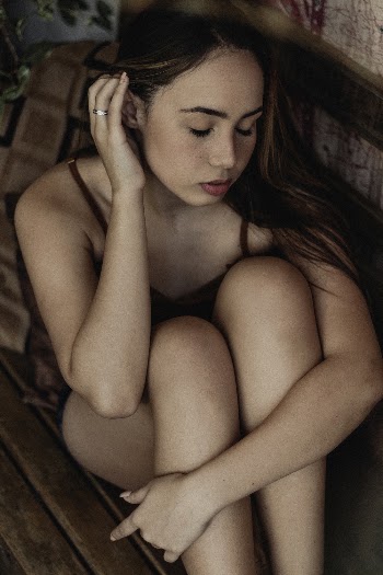 Woman Sitting on Brown Wooden Bench