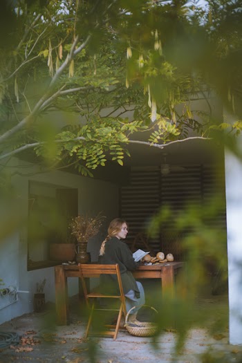 Woman Sitting On Brown Wooden Chair
