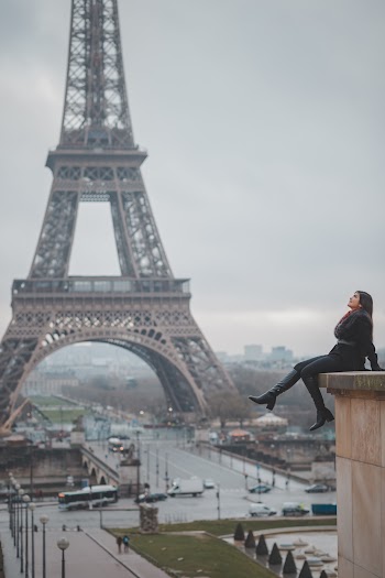 Woman Sitting on Buildings Rooftop Near Eiffel Tower, Paris