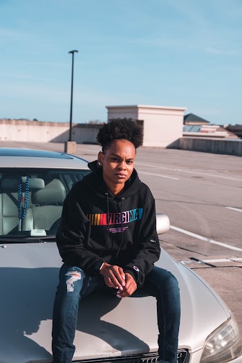 Woman Sitting on Car Hood