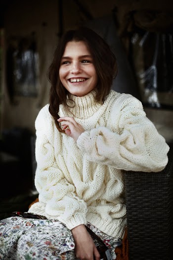 Woman Sitting on Chair and Smiling