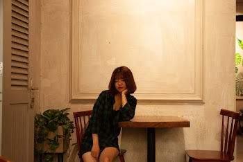 Woman Sitting On Chair Beside Table