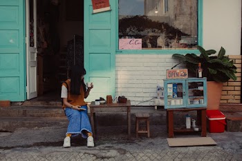 Woman Sitting on Chair by the Table