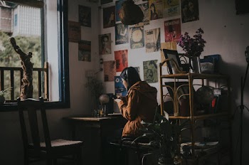 Woman Sitting on Chair Facing Table