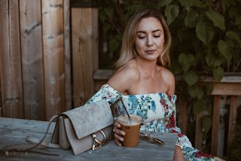 Woman Sitting On Chair Holding Disposable Cup