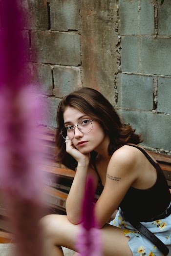 Woman Sitting on Chair in Front of Wall