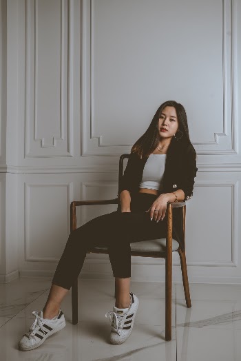 Woman Sitting on Chair Near Wall