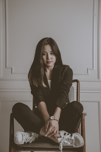 Woman Sitting on Chair Near Wall