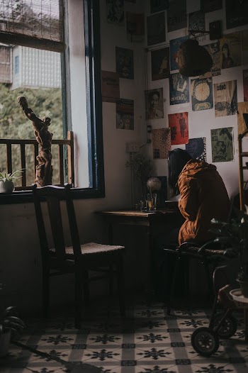 Woman Sitting on Chair Near Window