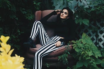 woman sitting on chair surrounded by plants