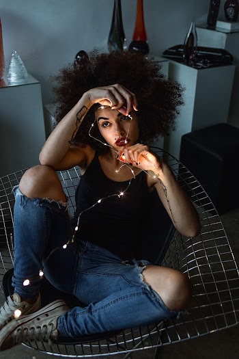Woman Sitting On Chair Wearing Tank Top