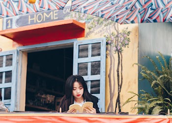 Woman Sitting on Chair While Reading Book