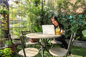 Woman Sitting on Chair While Using Laptop
