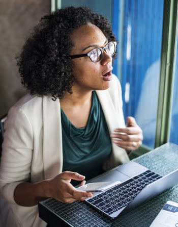 Woman Sitting on Chair While Using Laptop Computer