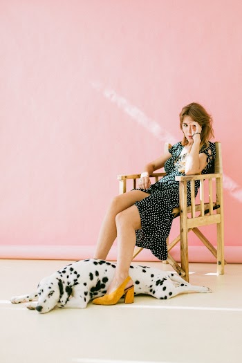 Woman Sitting On Chair With Dalmatian