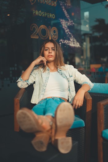 Woman Sitting on Chair With Her Foot on Ottoman