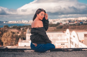 Woman Sitting on Cliff