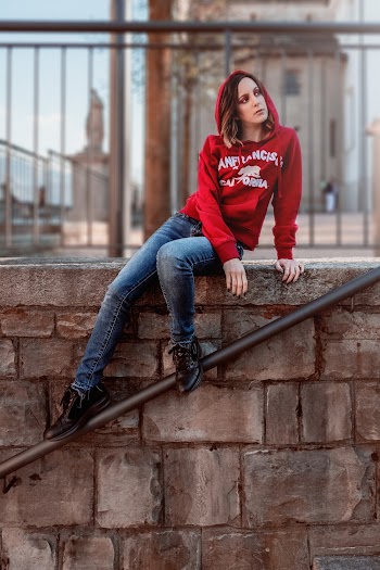 Woman Sitting on Concrete Block