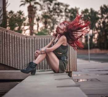 Woman Sitting On Concrete Floor