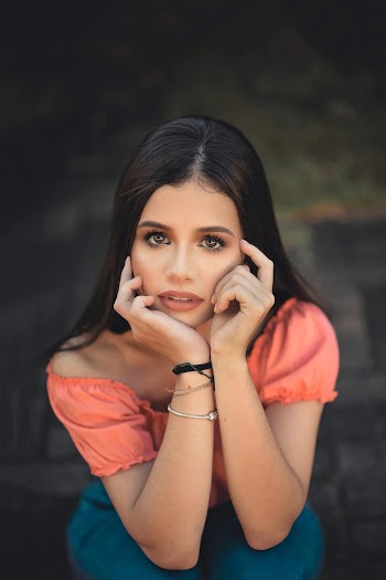 Woman Sitting on Concrete Ground