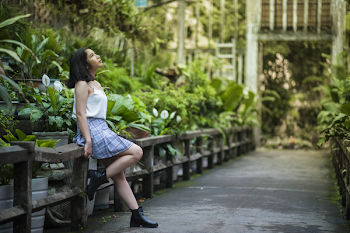 Woman Sitting on Concrete Handrail