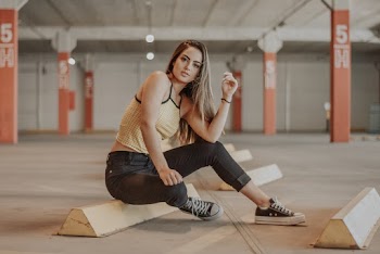 Woman Sitting on Concrete Ramp